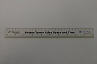 Photo of a specialized measuring device, resembling a ruler, designed to measure the speed of light. The device includes a precisely marked scale used to determine the distance (in centimeters) light travels in a given time (in pico seconds).