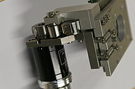 Photo of a microscope z-drive. Metal part that makes up the mechanical or motorized focusing mechanism. 